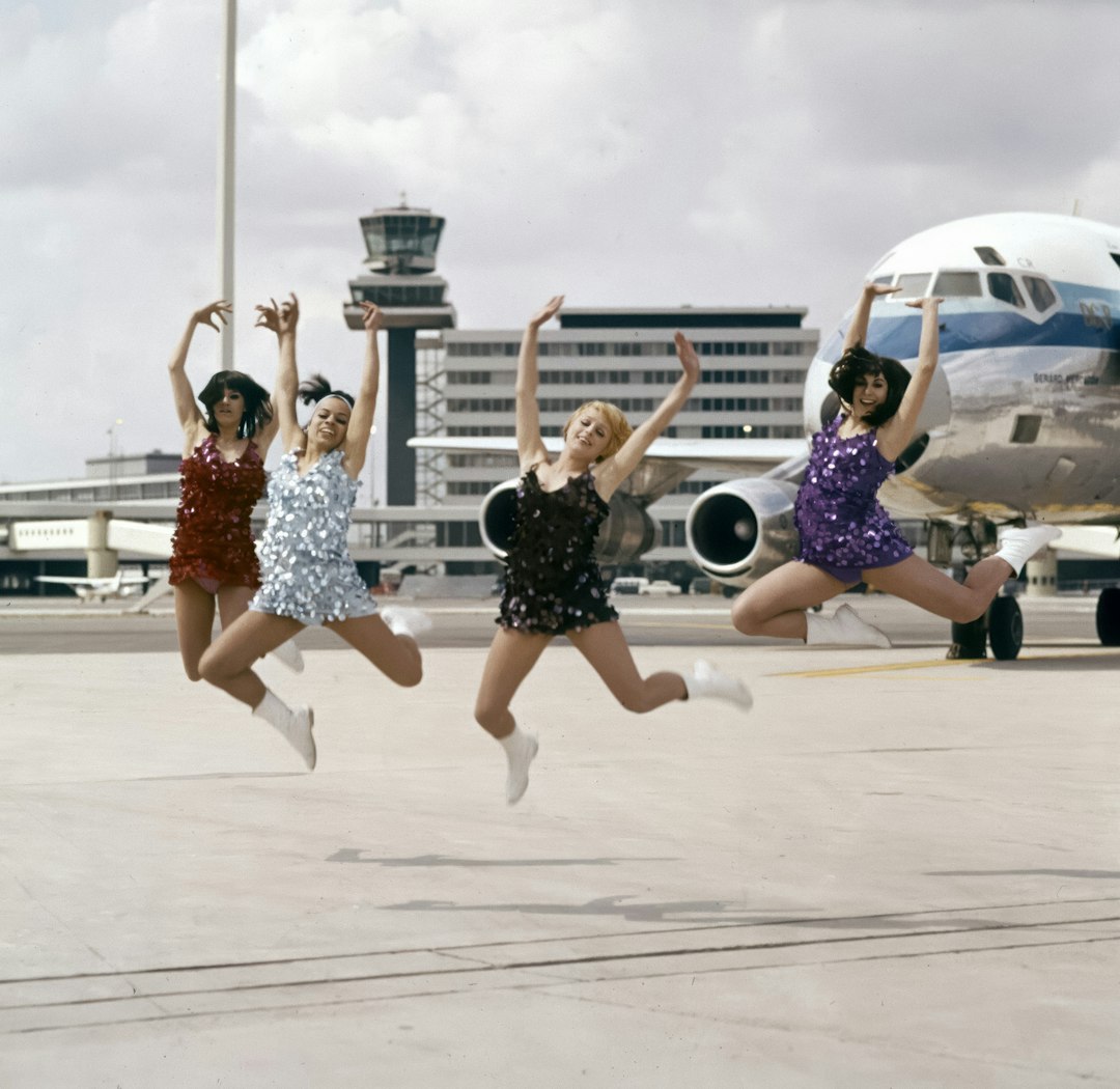 Friends jumping for joy at the airport