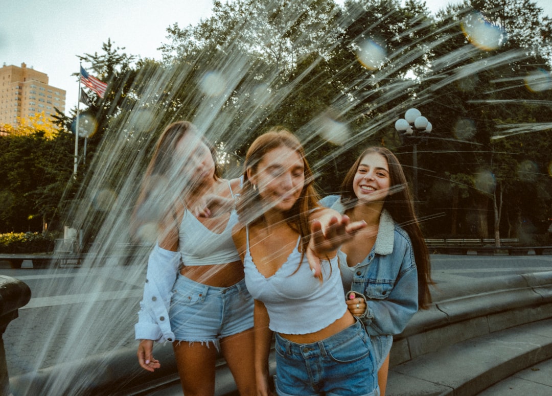 Three girlfriends laughing together on a trip